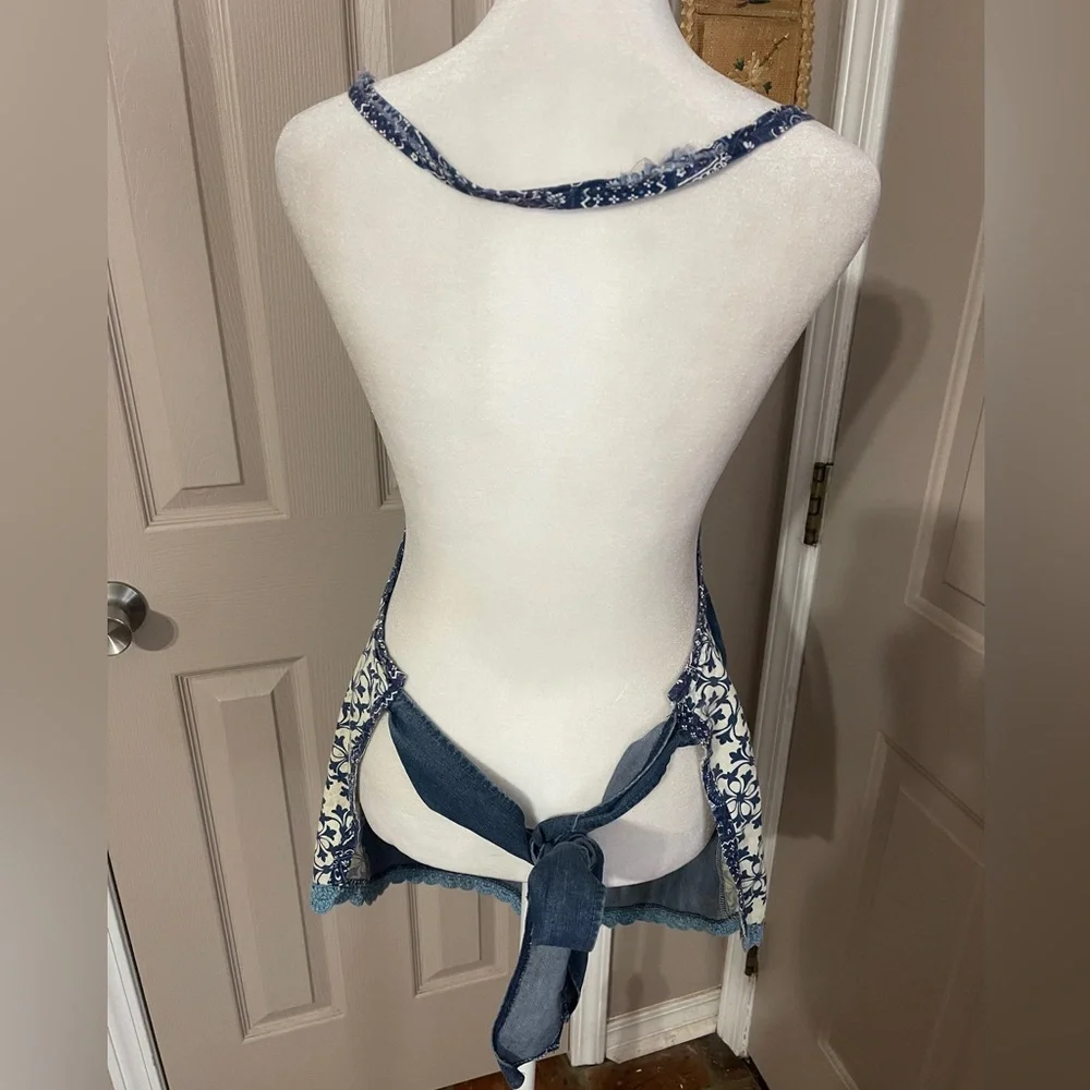 Vintage medium wash light weight ruffled denim apron with embroidered pocket.